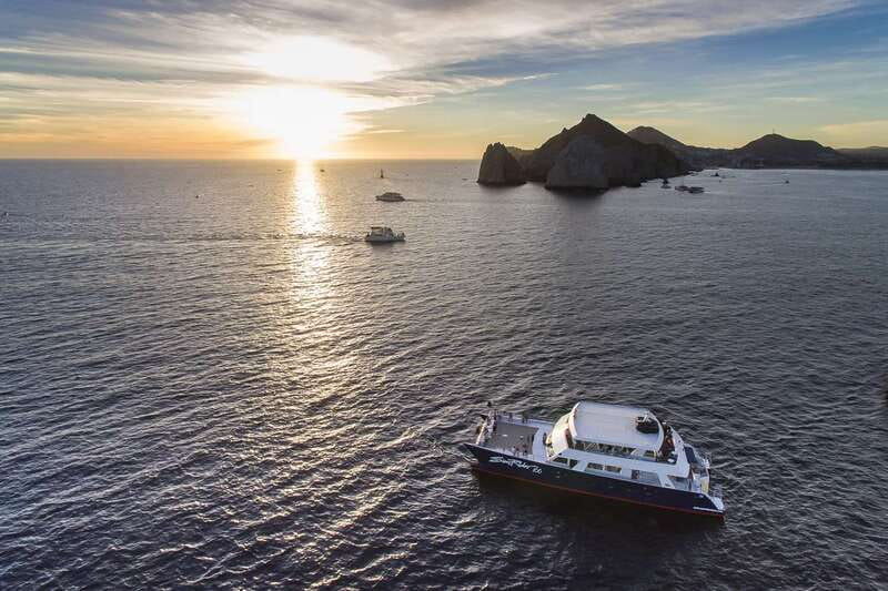 Cabo San Lucas: Sunset Dinner Cruise - Pacific-side rock views and resort coastline from the water